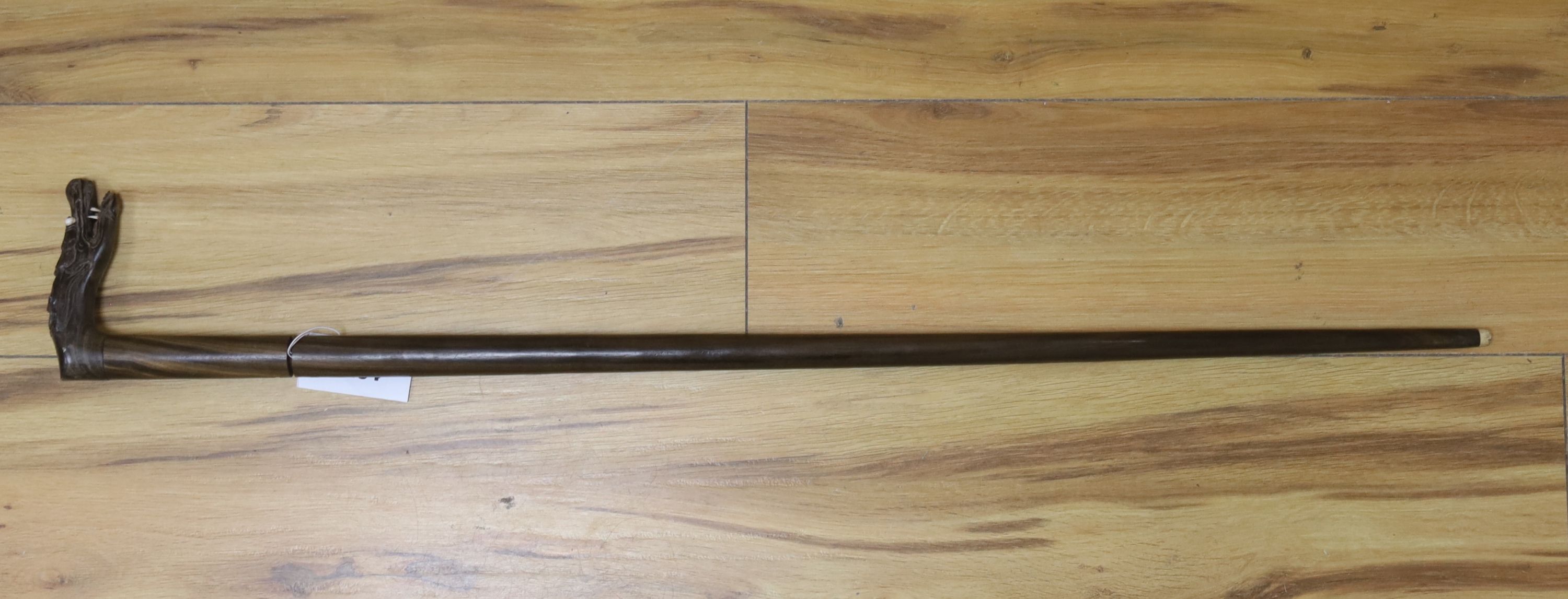 An early 20th century Indonesian coromandel stiletto walking stick, dragon handled, length 88cm